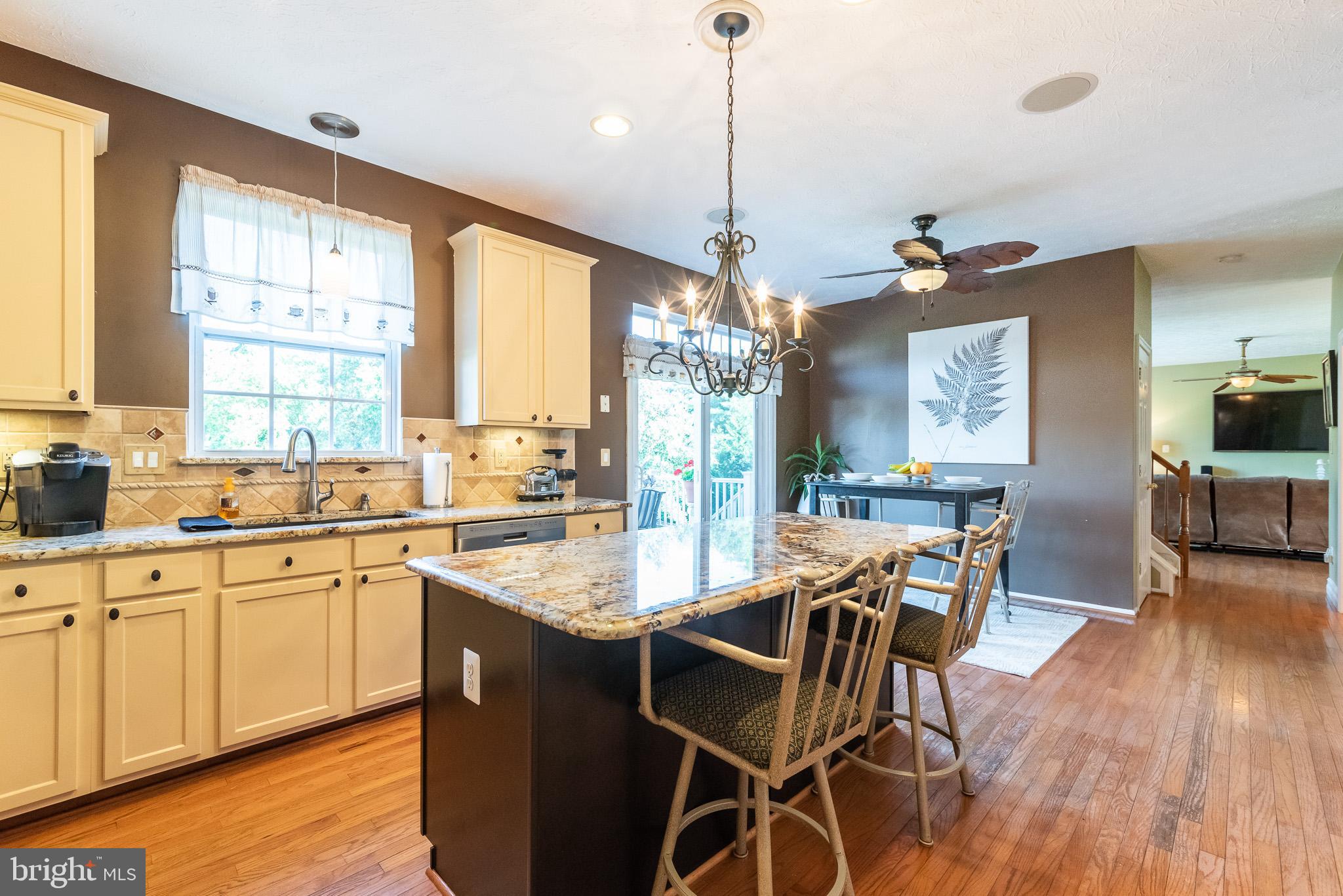 1907 Wagner Farm Road Bel Air, MD 21015 - Photo 15 of 67 a very nice looking kitchen with granite countertop a stove a sink a dining table and chairs