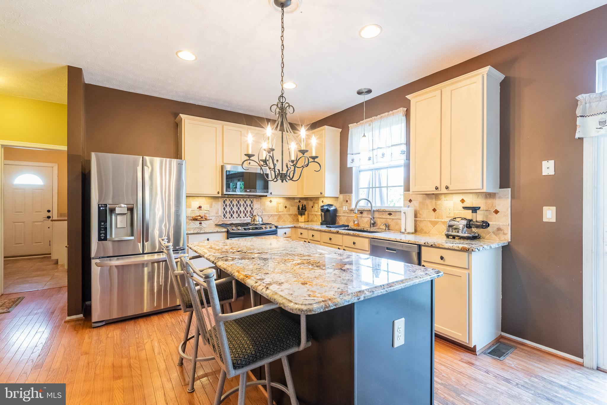 1907 Wagner Farm Road Bel Air, MD 21015 - Photo 16 of 67 a kitchen with stainless steel appliances granite countertop a stove and refrigerator