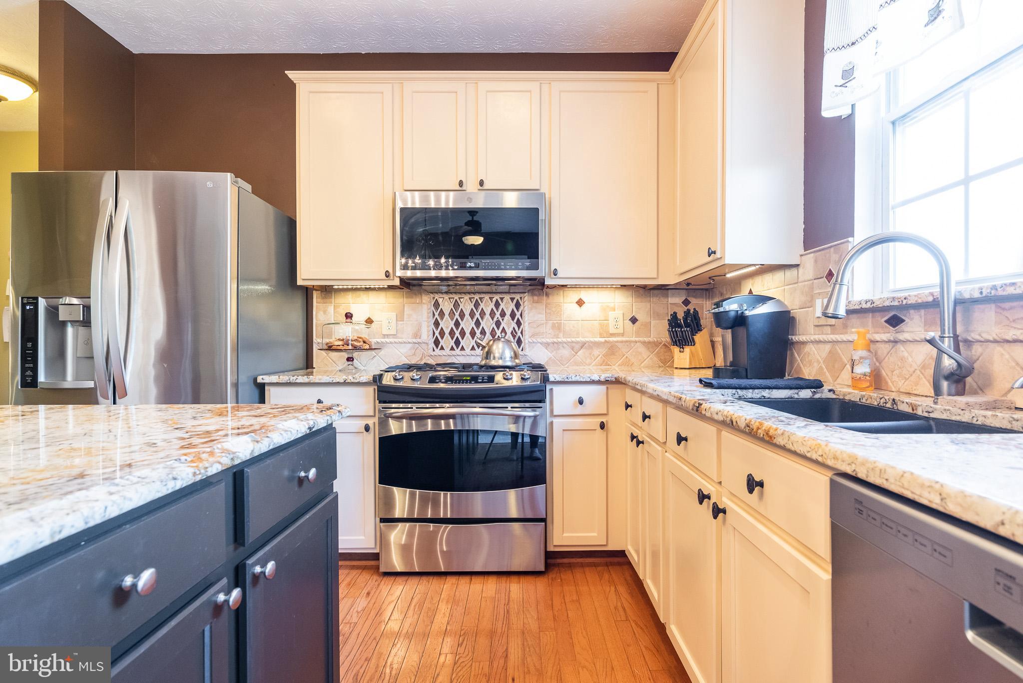 1907 Wagner Farm Road Bel Air, MD 21015 - Photo 20 of 67 a kitchen with stainless steel appliances granite countertop a stove a sink and a refrigerator