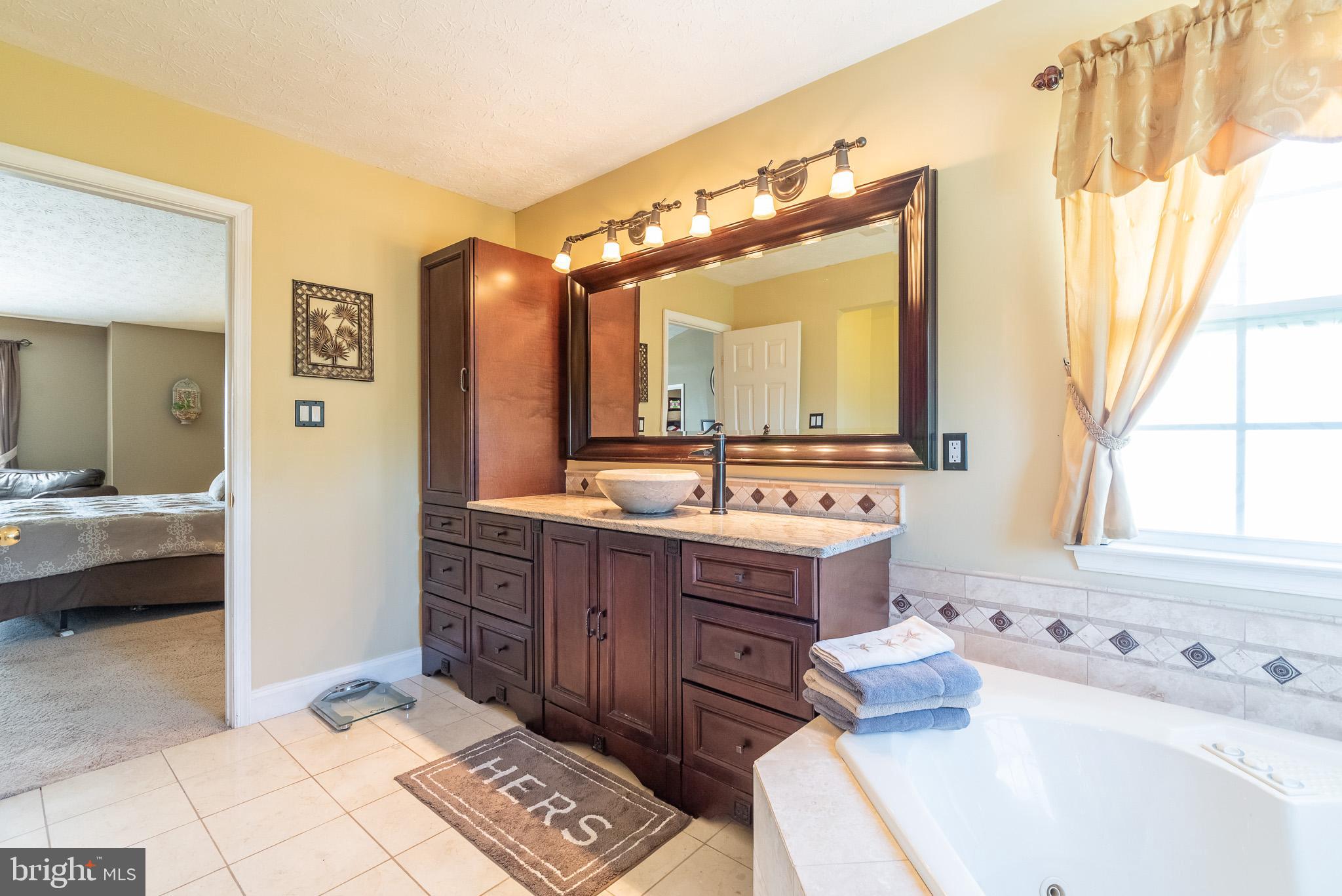 1907 Wagner Farm Road Bel Air, MD 21015 - Photo 31 of 67 a bathroom with a tub sink and mirror