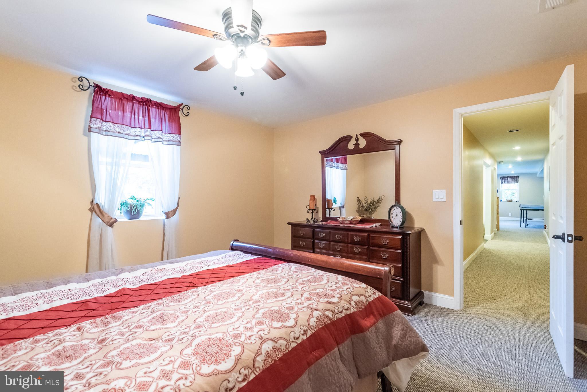 1907 Wagner Farm Road Bel Air, MD 21015 - Photo 49 of 67 a bedroom with a bed and a chandelier