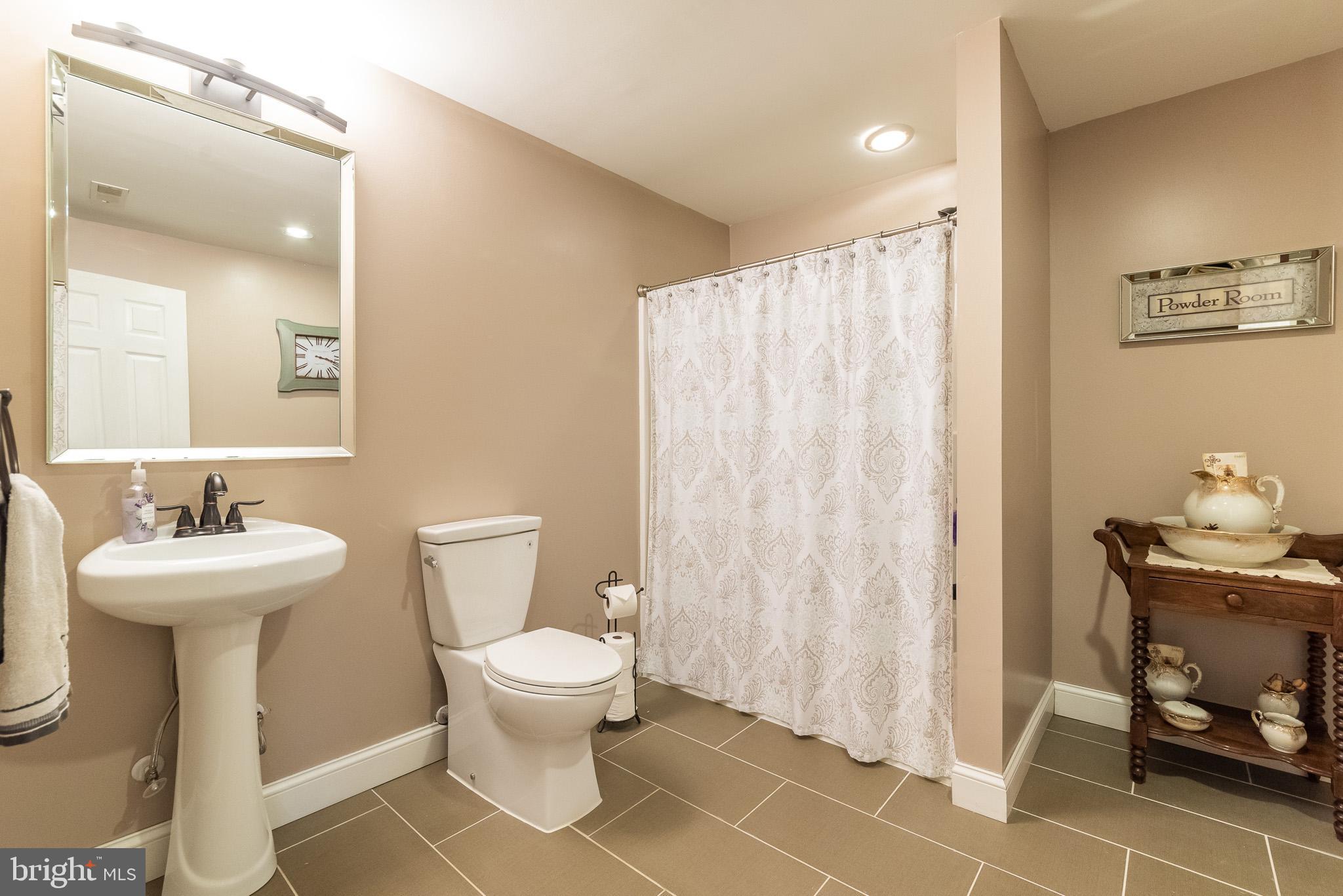 1907 Wagner Farm Road Bel Air, MD 21015 - Photo 50 of 67 a bathroom with a sink toilet and a mirror