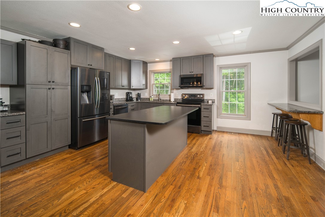 1527 Mabel School Road Zionville, NC 28698 - Photo 13 of 49 a kitchen with stainless steel appliances granite countertop a refrigerator a stove top oven a sink and dishwasher