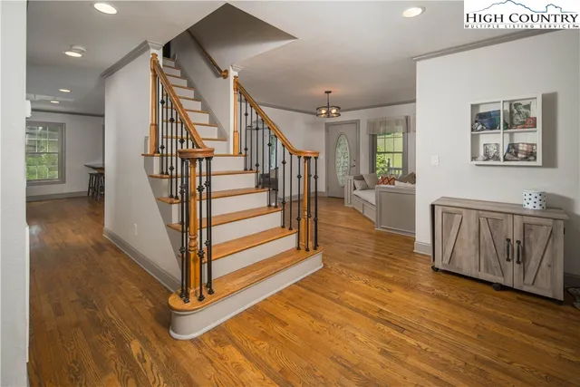 a bedroom with a bed wooden floor and window