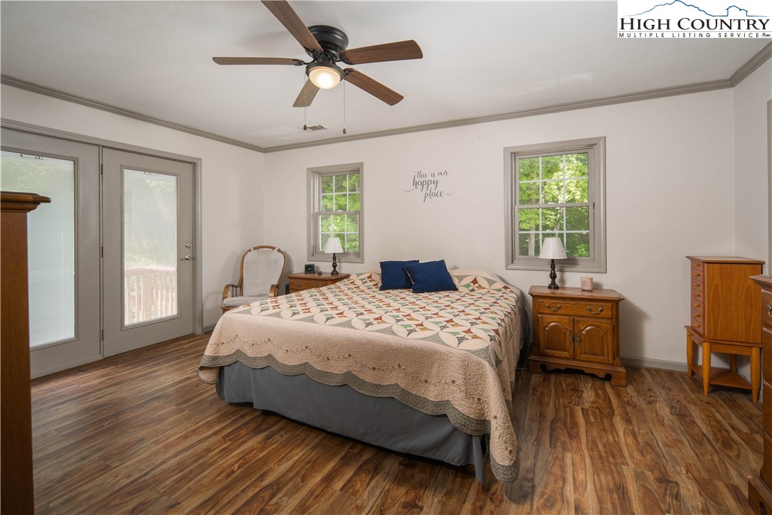 1527 Mabel School Road Zionville, NC 28698 - Photo 25 of 49 a bedroom with a bed wooden floor and window