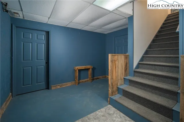 a view of an empty room with furniture and windows