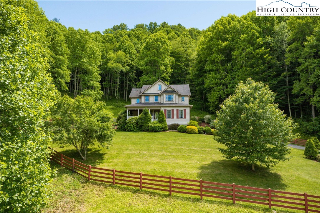 1527 Mabel School Road Zionville, NC 28698 - Photo 6 of 49 a view of a house with a big yard and large trees