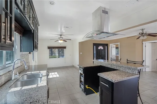 a view of a kitchen with furniture and a ceiling fan