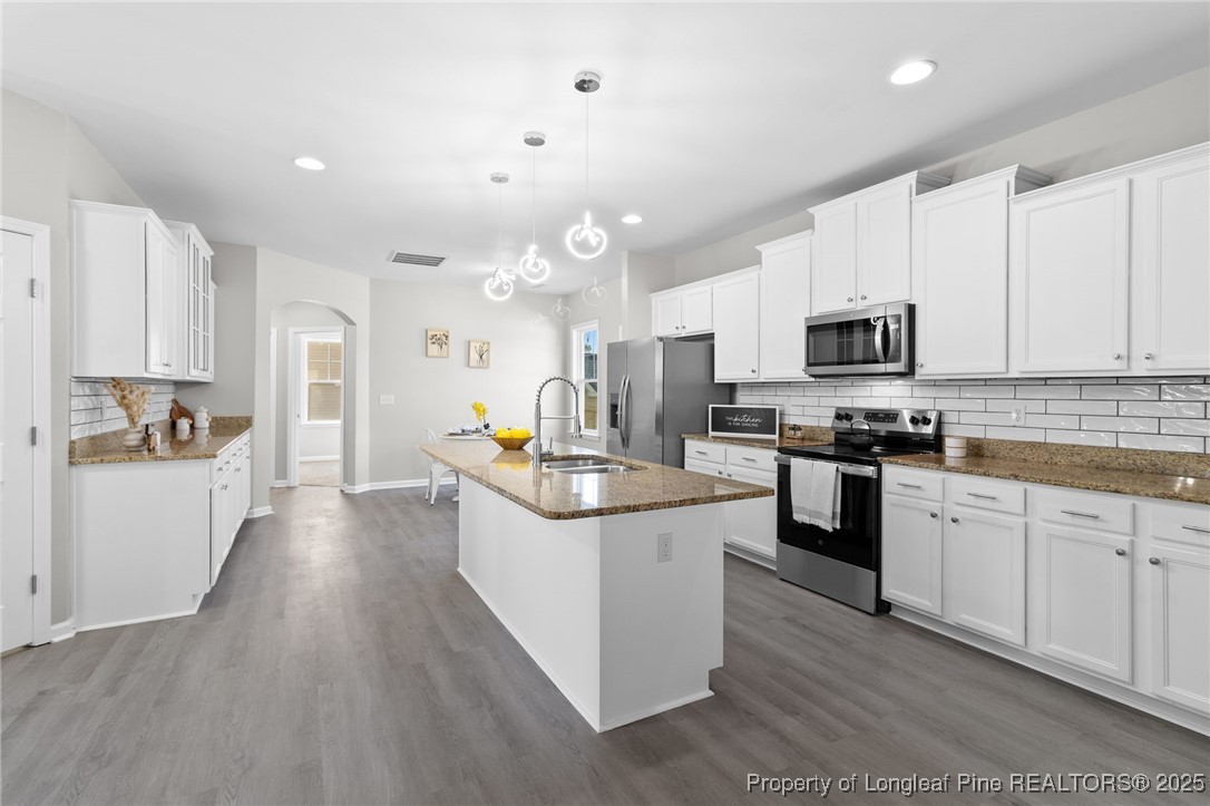 516 Heathrow Drive Spring Lake, NC 28390 - Photo 12 of 42 a kitchen with kitchen island granite countertop a sink a counter top space stainless steel appliances and cabinets