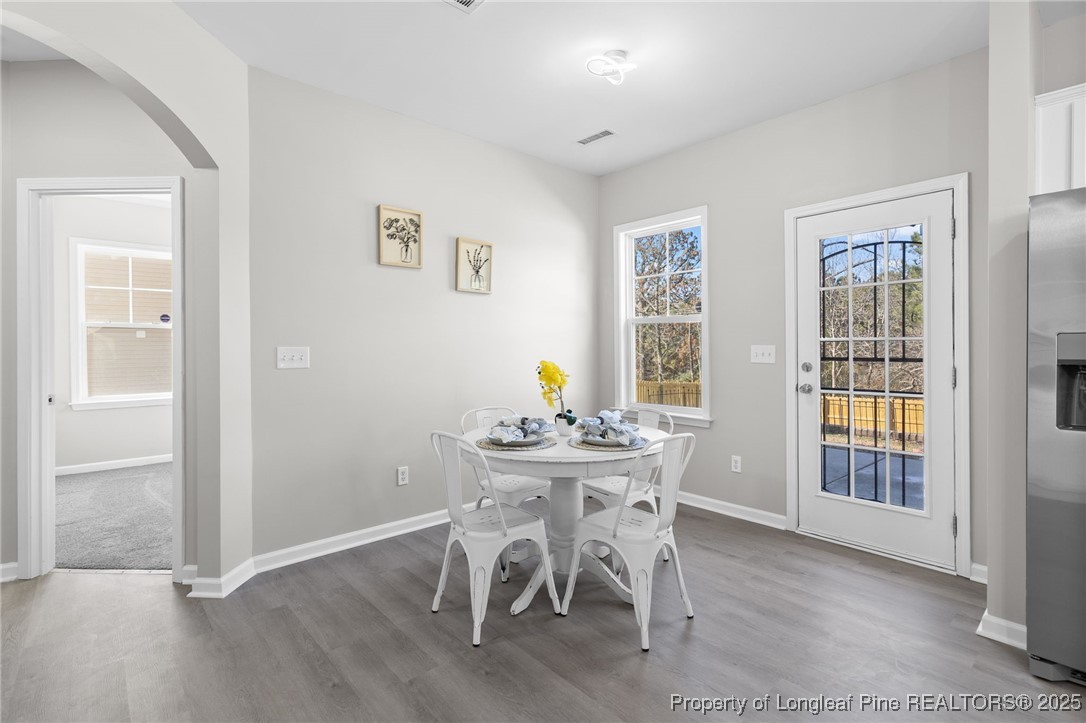 516 Heathrow Drive Spring Lake, NC 28390 - Photo 16 of 42 a view of a dining room with furniture and wooden floor