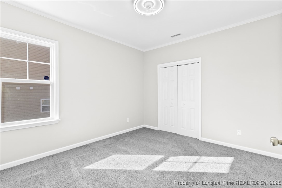 516 Heathrow Drive Spring Lake, NC 28390 - Photo 18 of 42 a view of an empty room with wooden floor and a window