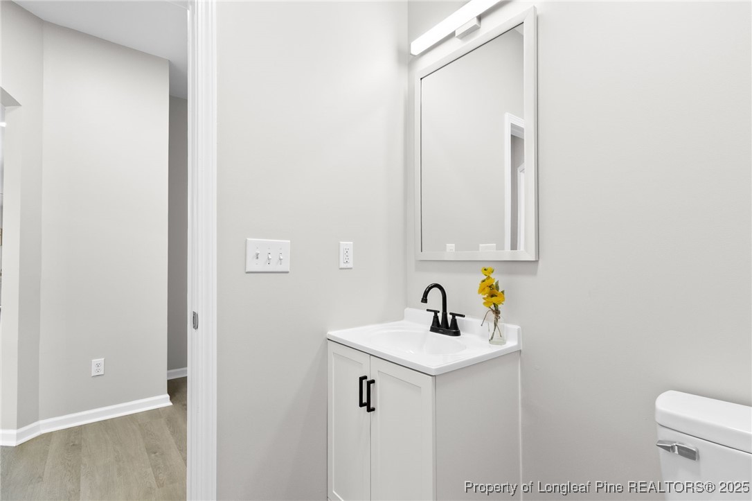 516 Heathrow Drive Spring Lake, NC 28390 - Photo 20 of 42 a bathroom with a sink a toilet and mirror