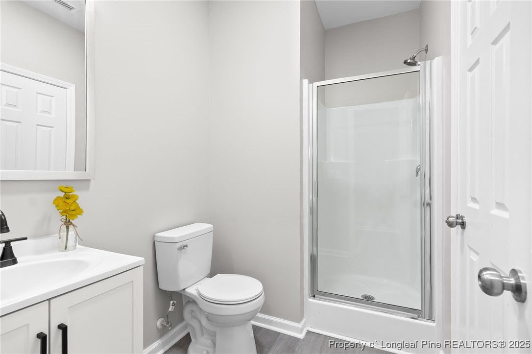 516 Heathrow Drive Spring Lake, NC 28390 - Photo 21 of 42 a bathroom with a sink a toilet and shower