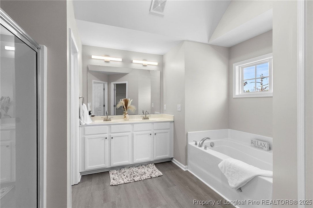 516 Heathrow Drive Spring Lake, NC 28390 - Photo 26 of 42 a bathroom with a tub sink and mirror