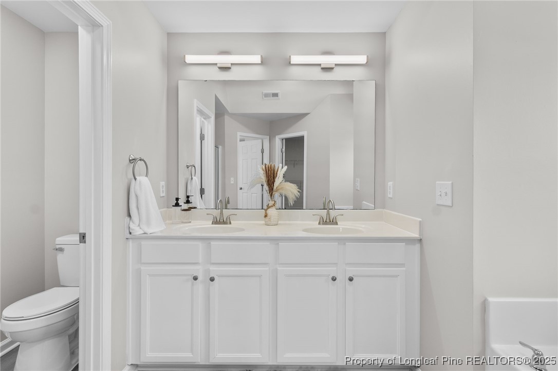 516 Heathrow Drive Spring Lake, NC 28390 - Photo 27 of 42 a bathroom with a sink and a mirror