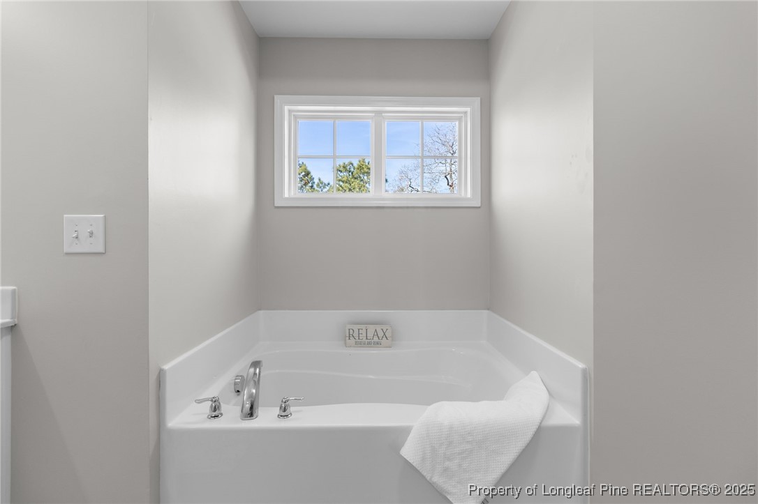 516 Heathrow Drive Spring Lake, NC 28390 - Photo 29 of 42 a bathroom with a bathtub and window