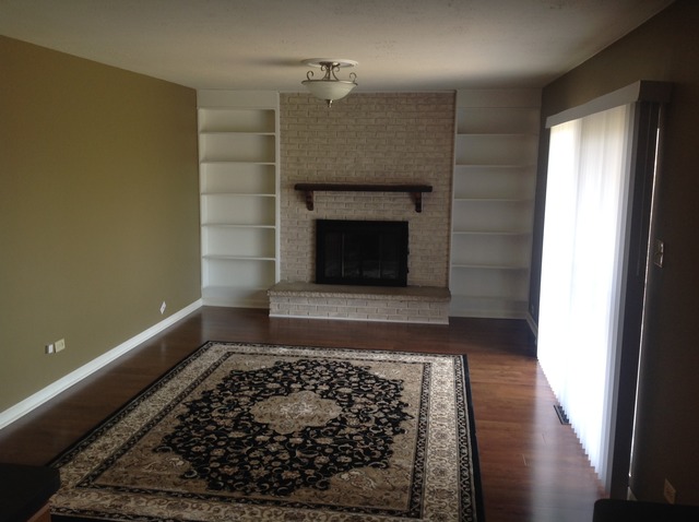 617 Quail Run Road Matteson, IL 60443 - Photo 11 of 13 a room with wooden floor and a fireplace