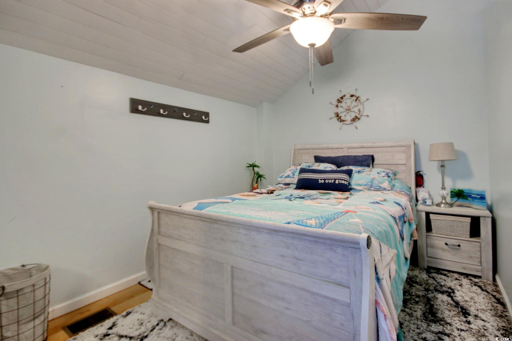503 Pinewood Road, Unit 2H Myrtle Beach, SC 29577 - Photo 20 of 34 Bedroom with lofted ceiling, a ceiling fan, and wood finished floors