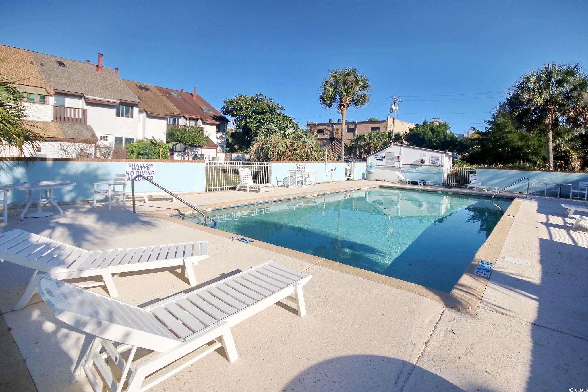 Community pool with a patio