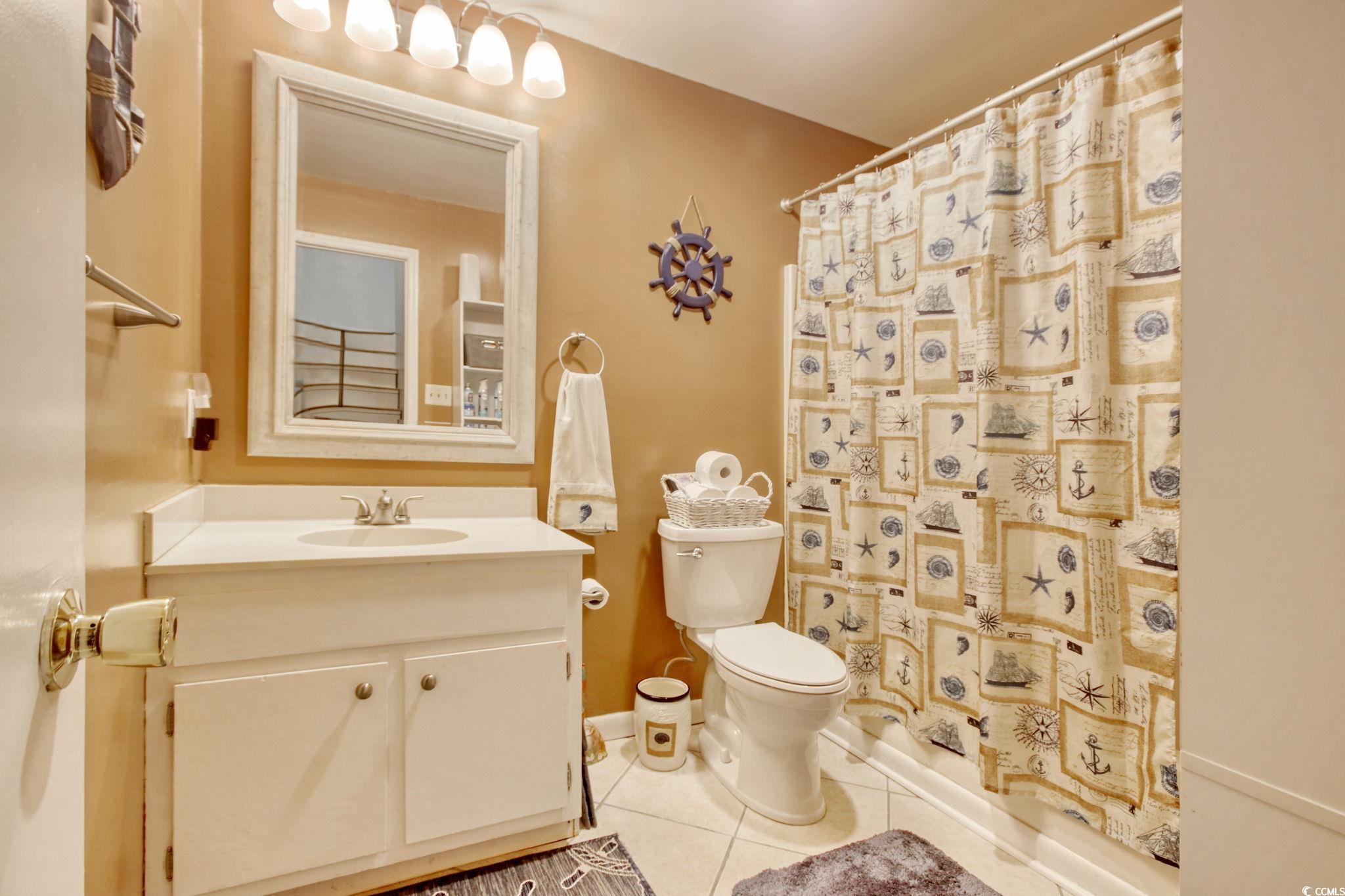 503 Pinewood Road, Unit 2H Myrtle Beach, SC 29577 - Photo 24 of 34 Bathroom with light tile patterned flooring and vanity