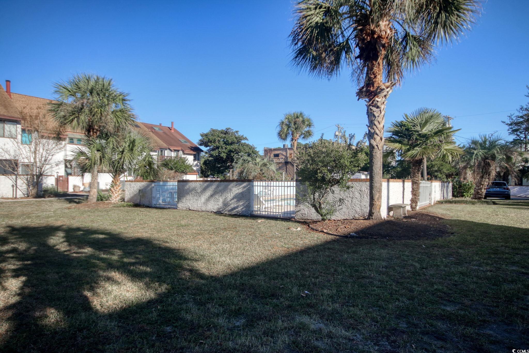 503 Pinewood Road, Unit 2H Myrtle Beach, SC 29577 - Photo 30 of 34 Community pool with a patio