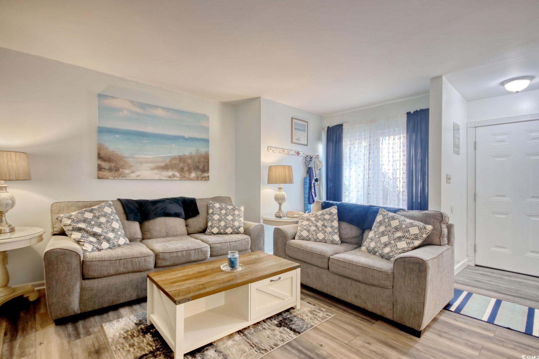 Living area with light wood-type flooring and baseboards