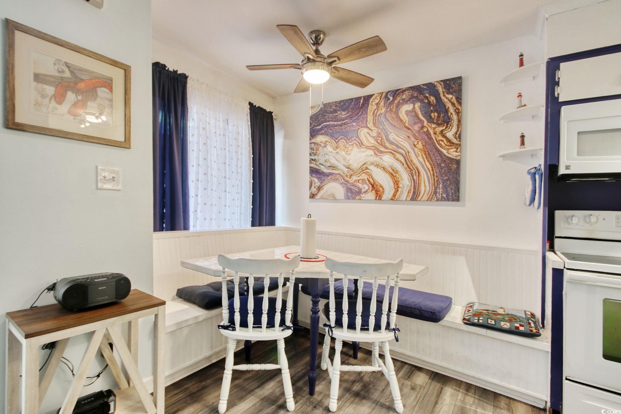 503 Pinewood Road, Unit 2H Myrtle Beach, SC 29577 - Photo 9 of 34 Dining space featuring wood finished floors, ceiling fan, and breakfast area