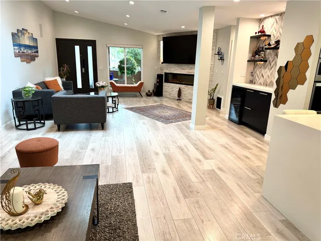 a living room with kitchen island furniture and a large window