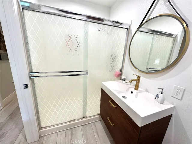 a bathroom with a sink a toilet a mirror and shower curtain