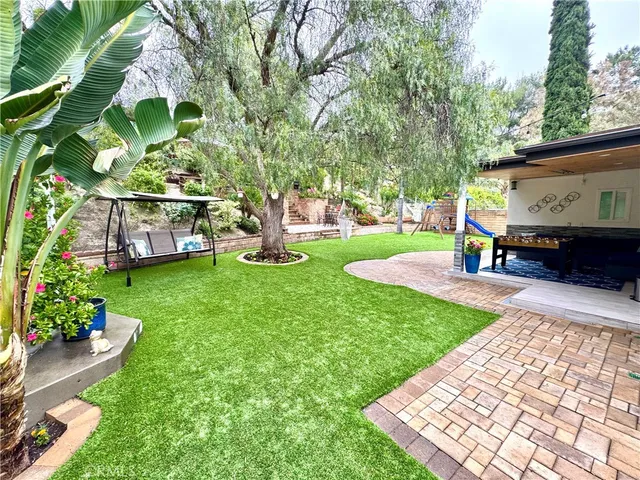 a view of a backyard with sitting area