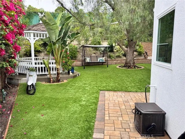 a view of a backyard with sitting area