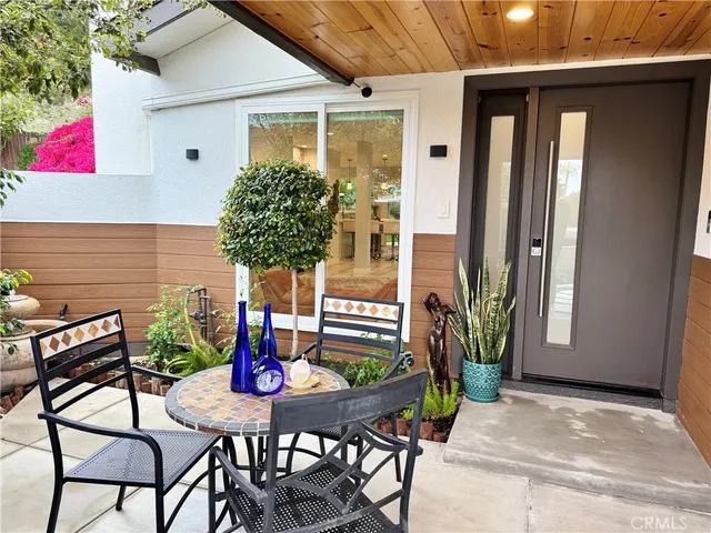 a backyard of a house with table and chairs