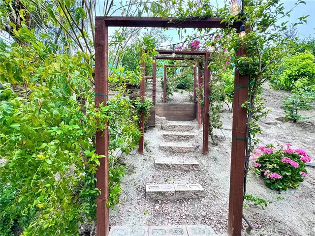 a view of flower garden with wooden fence