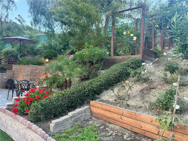 a view of a wooden bench sitting in the middle of a yard