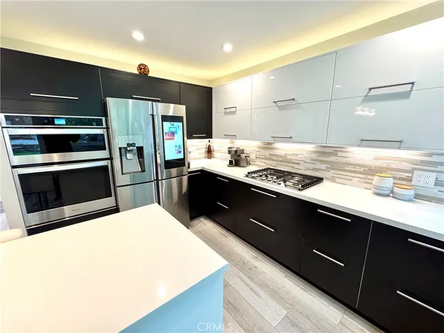 a kitchen with stainless steel appliances a sink and a stove