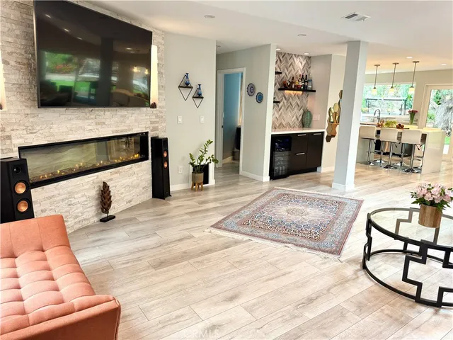 a living room with furniture a large window and gym equipment