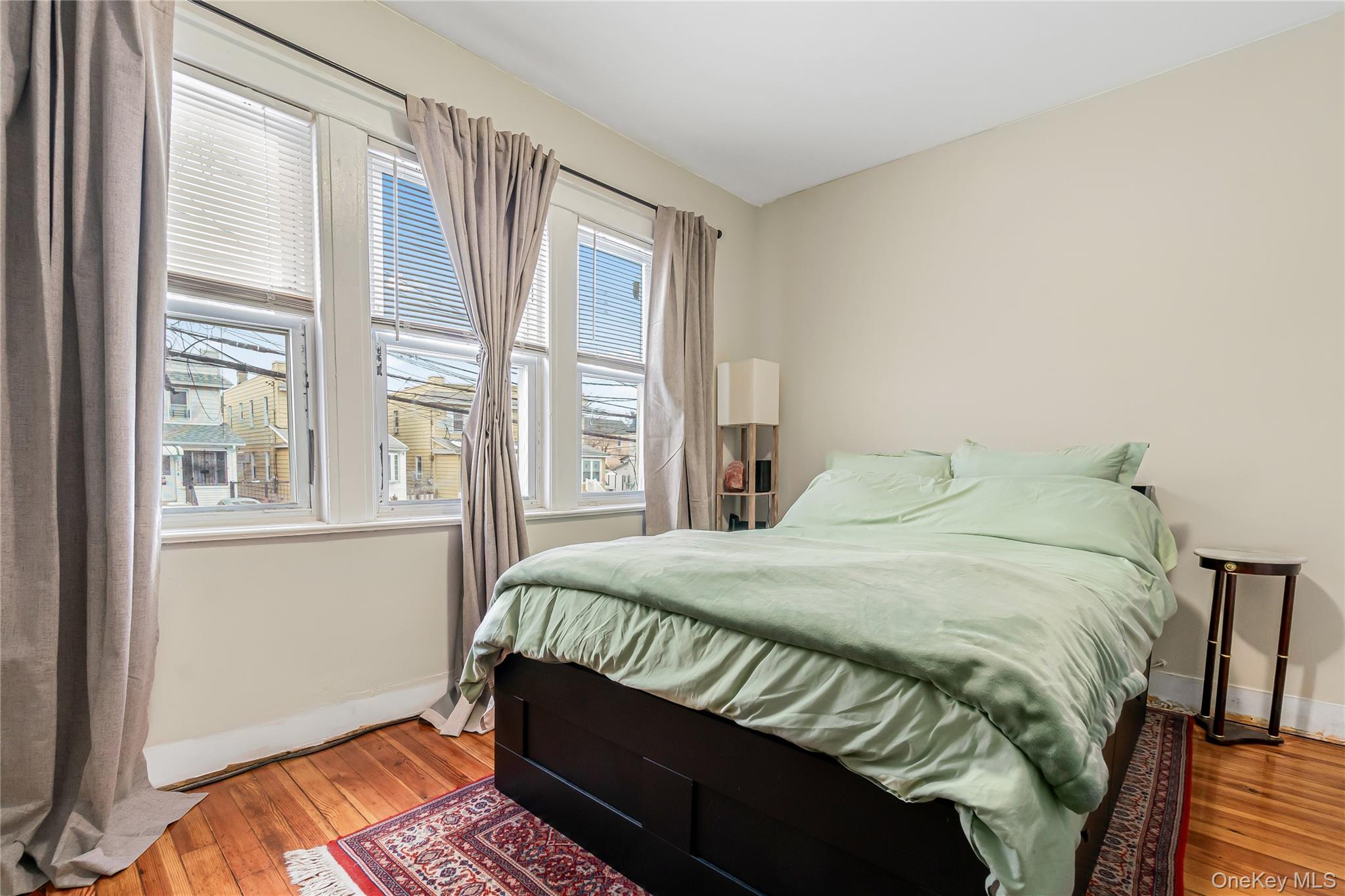 85-14 Sutter Avenue Queens, NY 11417 - Photo 17 of 27 Spacious Bedroom featuring hardwood floors, large windows for natural light and baseboards