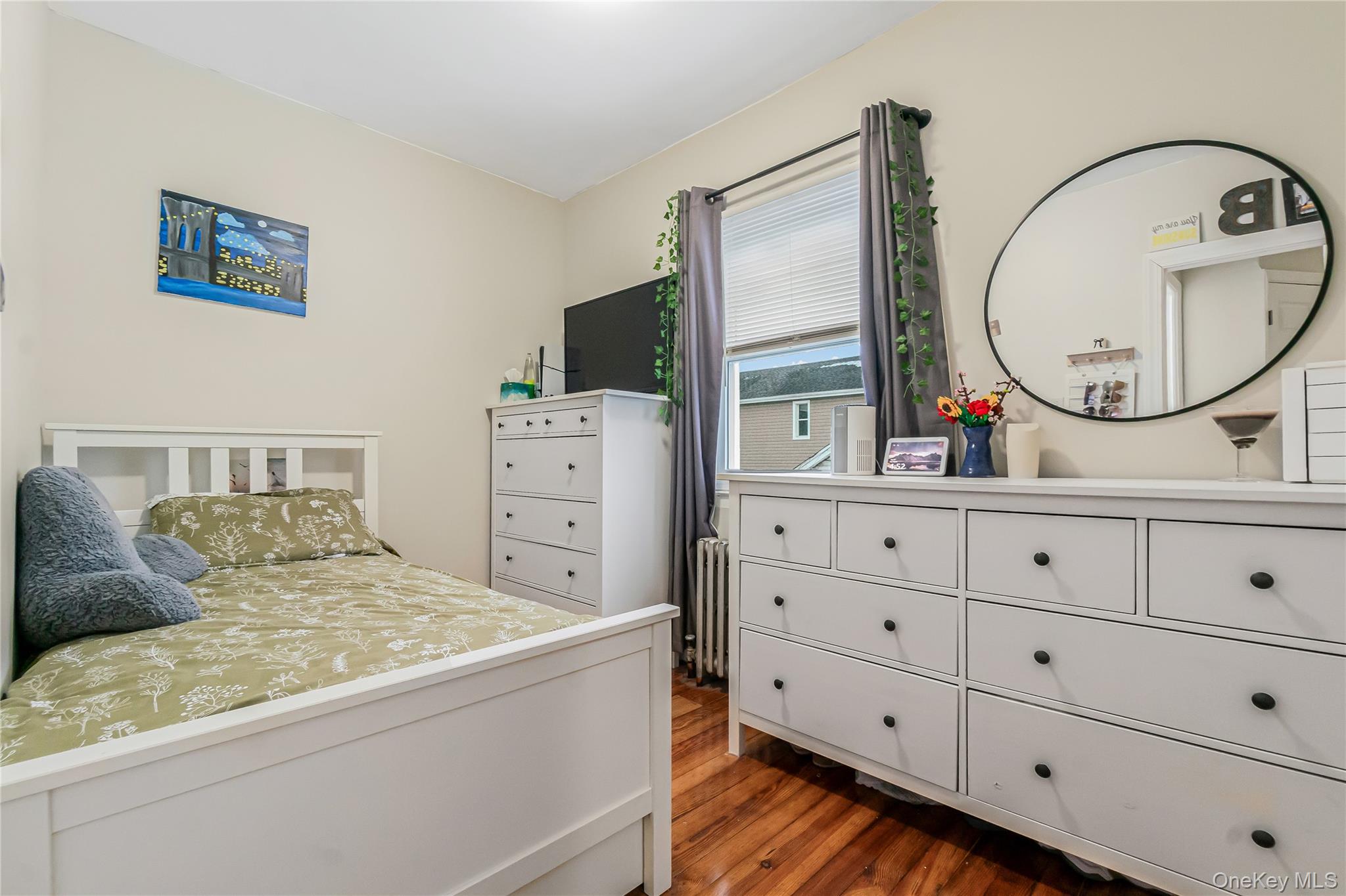 85-14 Sutter Avenue Queens, NY 11417 - Photo 21 of 27 3rd Bedroom featuring wood floors and radiator heating unit