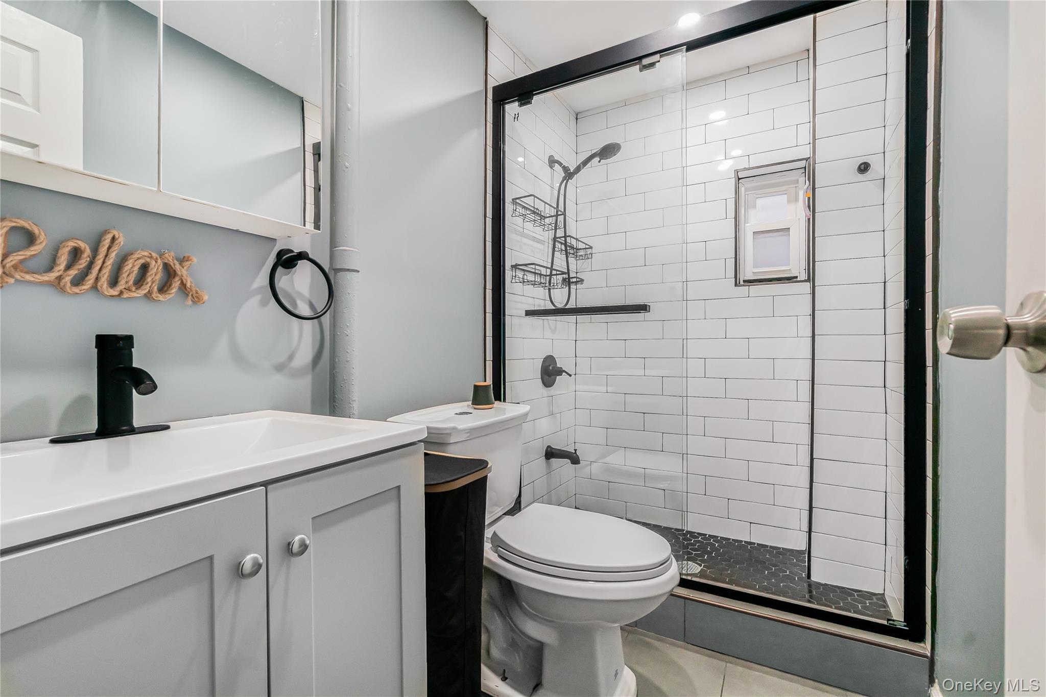 85-14 Sutter Avenue Queens, NY 11417 - Photo 23 of 27 Bathroom with vanity and a shower stall