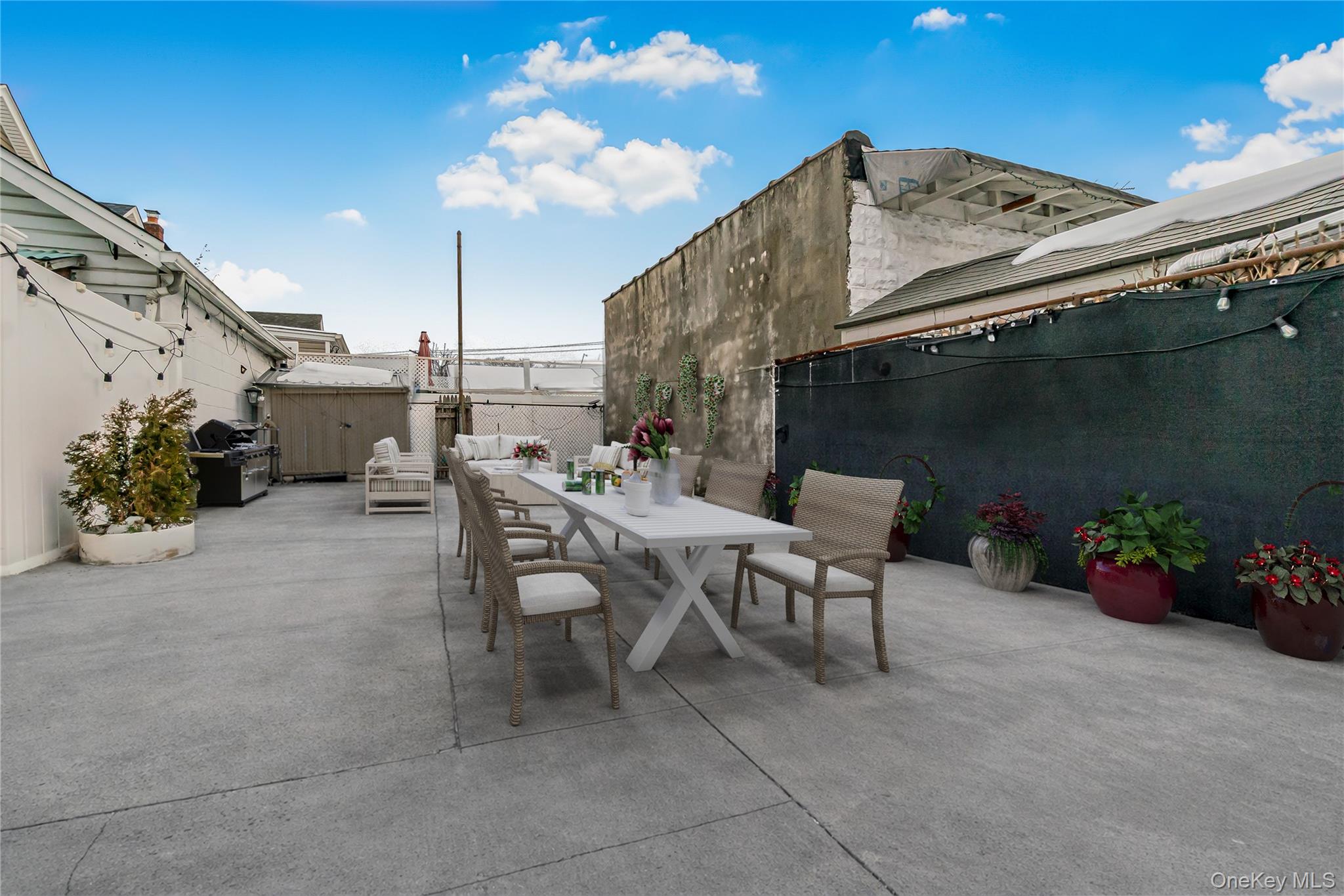 85-14 Sutter Avenue Queens, NY 11417 - Photo 25 of 27 Fenced backyard featuring outdoor dining area and area for grilling . Staged