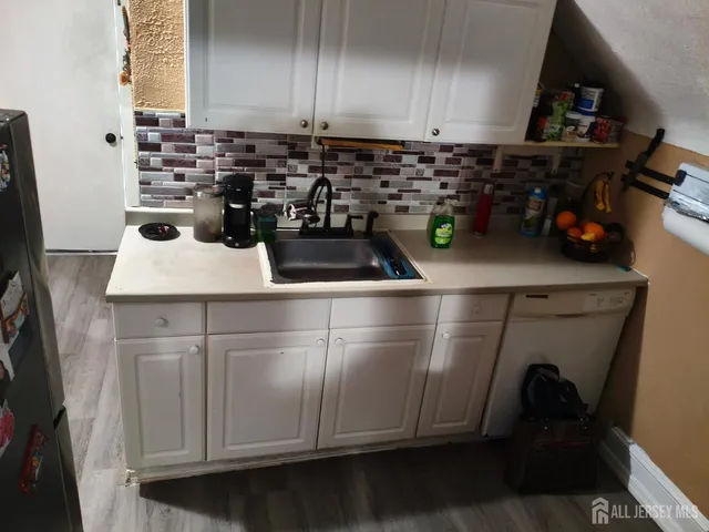 a kitchen with a sink and cabinets