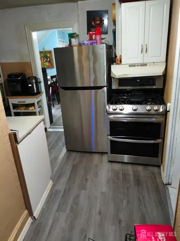 a refrigerator freezer sitting inside of a kitchen