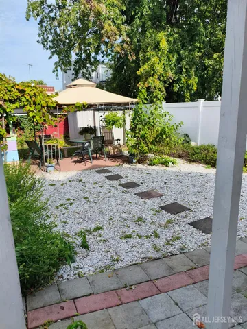 a view of a backyard with a patio and garden