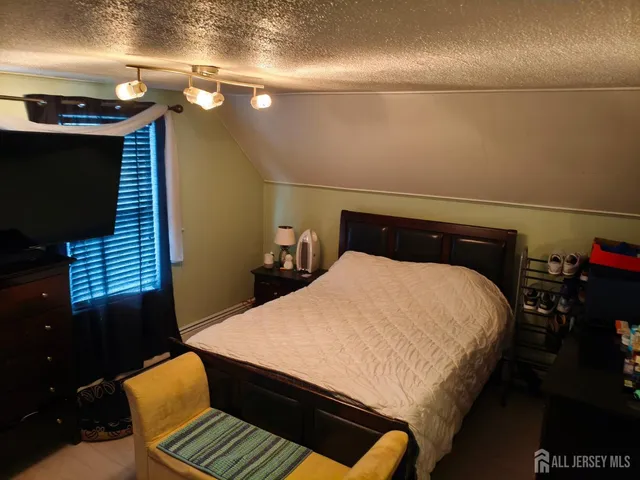 a bed sitting in a bedroom next to a bathroom