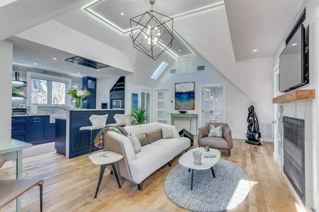 7 Brewer Street, Unit 2 Boston, MA 02130 - Photo 1 of 18 a living room with furniture a fireplace and a chandelier