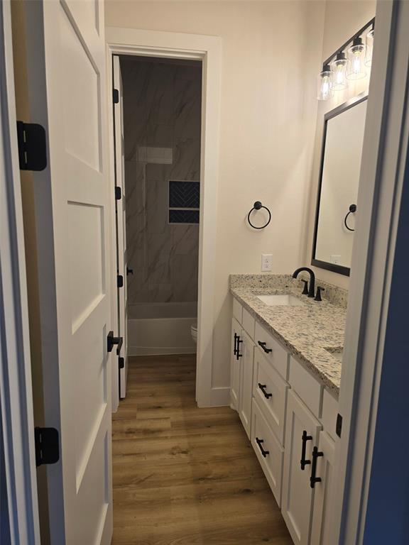 808 N Avenue East Springtown, TX 76082 - Photo 12 of 21 a bathroom with a granite countertop sink a mirror and shower