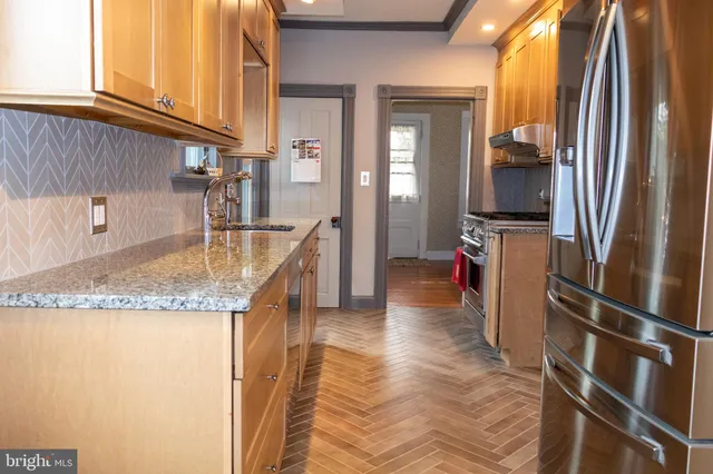 a view of kitchen with granite countertop cabinets and has wooden floor