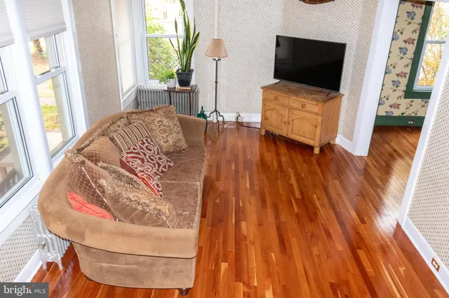 a view of a livingroom with wooden floor and stairs