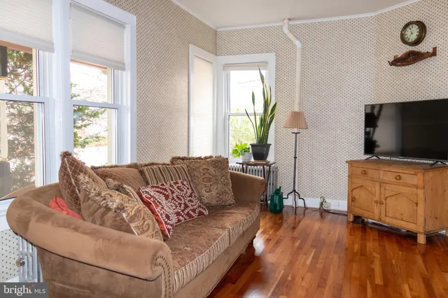 a view of a hallway with wooden floor and a fireplace