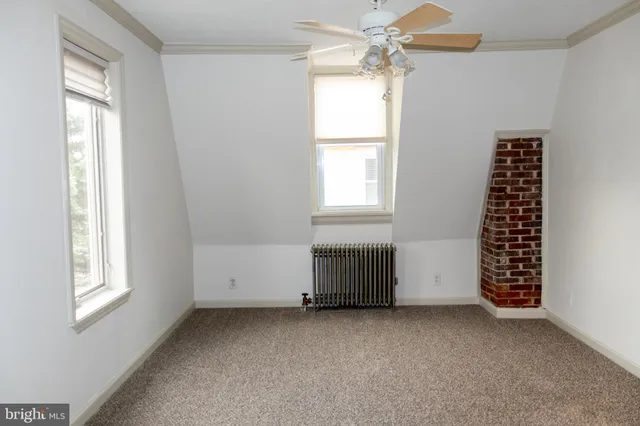 a view of a room with walk in closet with empty racks